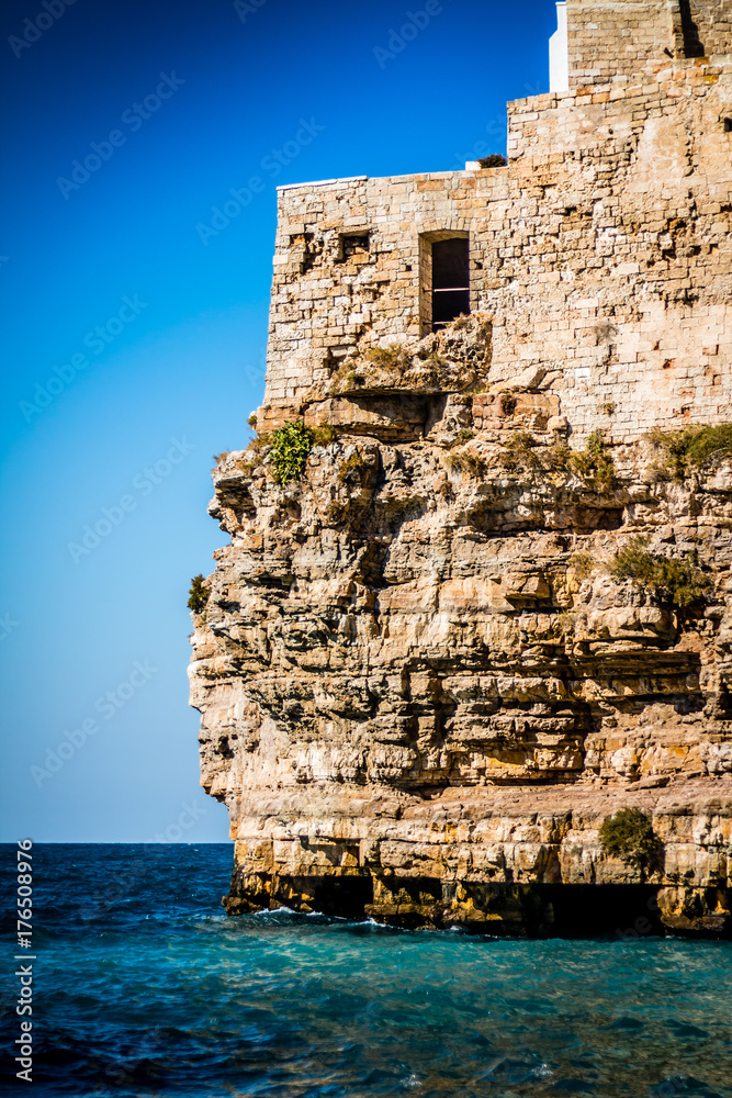 Old stone house on a cliff above the sea