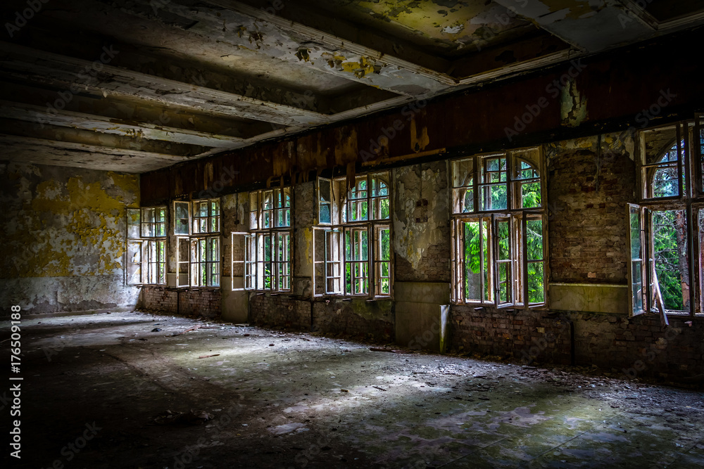 The sun's rays break the darkness in an abandoned destroyed room of an ancient building