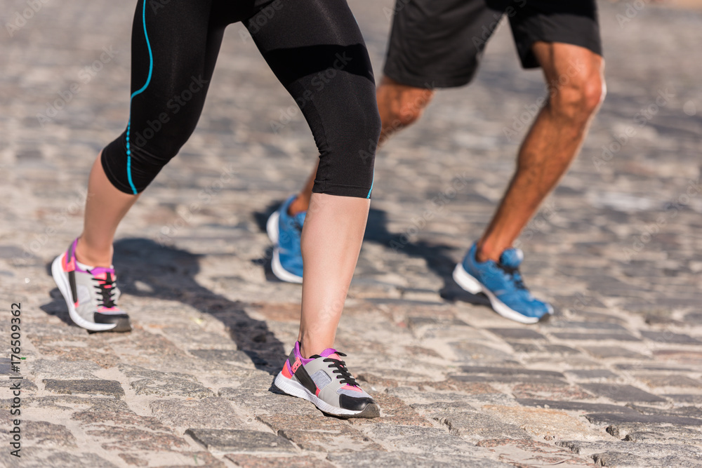 sports couple jogging in city