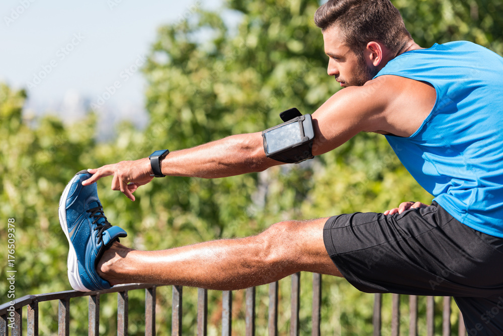 Fototapeta premium sportsman stretching in park