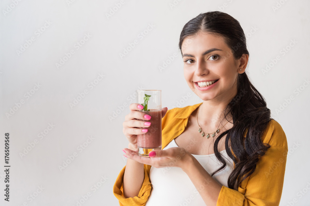 smiling woman showing detox drink smiling woman showing detox drink