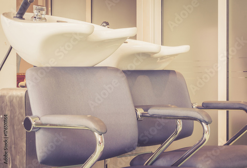 Beauty salon interior - a row of hair washing sinks - white washbasins for hairdresser