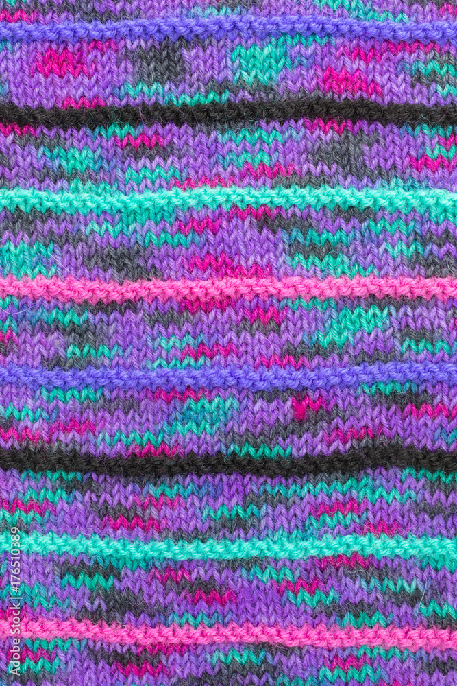 background of striped knitted fabric in multicolored yarn