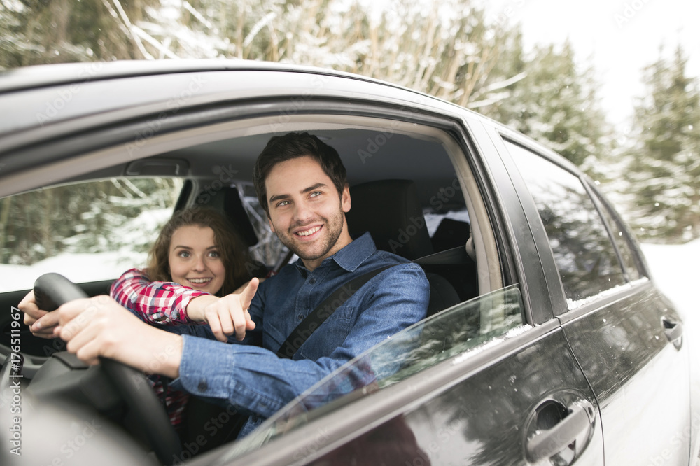Young couple on a road trip in winter Young couple on a road trip in winter