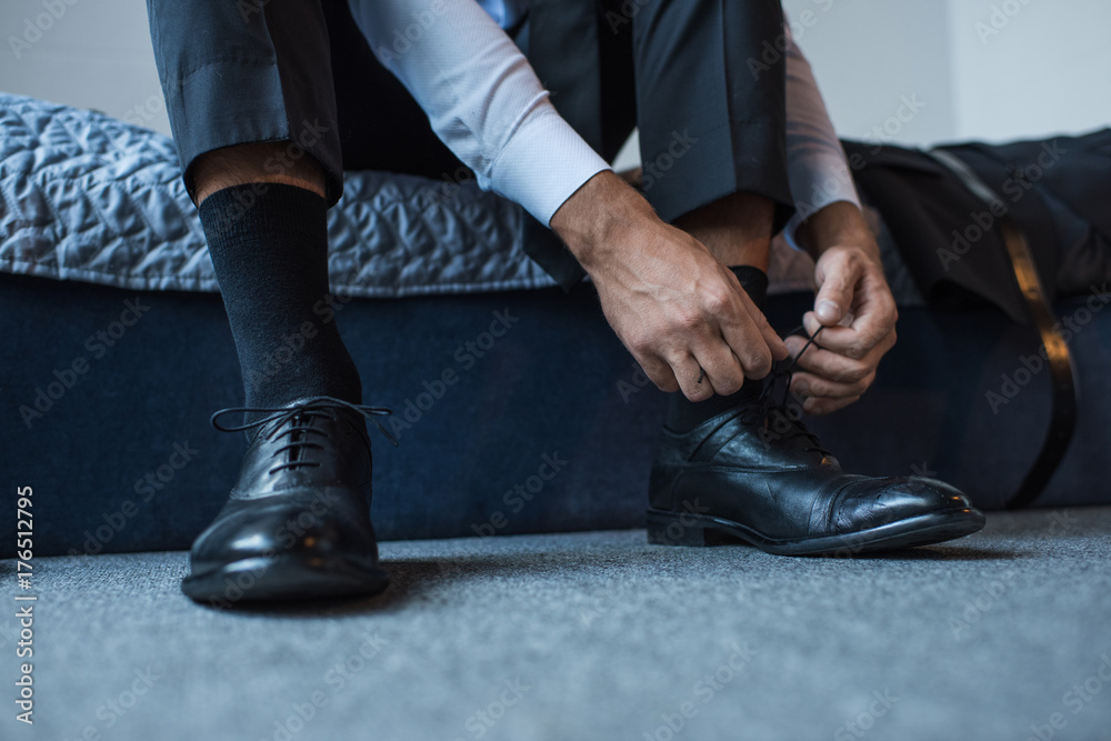 Fototapeta premium Man tying shoelaces