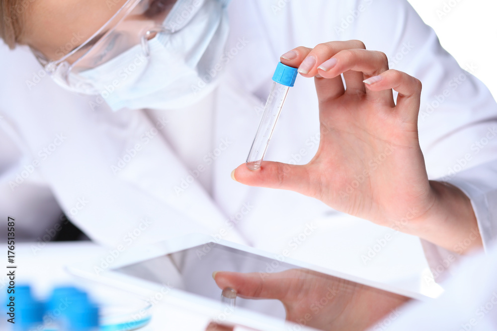 Close-up of scientific research team with clear solution in laboratory Close-up of scientific research team with clear solution in laboratory
