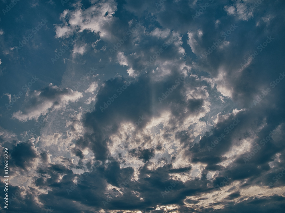 A bright blue sky with large clouds.