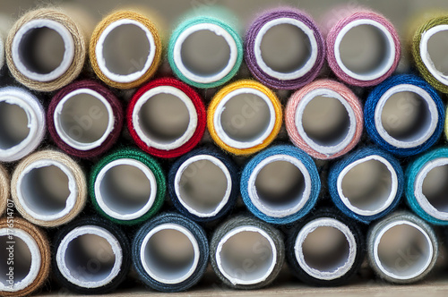 Close-up on colored sewing threads on spools