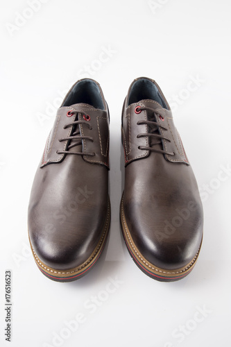 Male brown leather shoe on white background, isolated product, comfortable footwear.