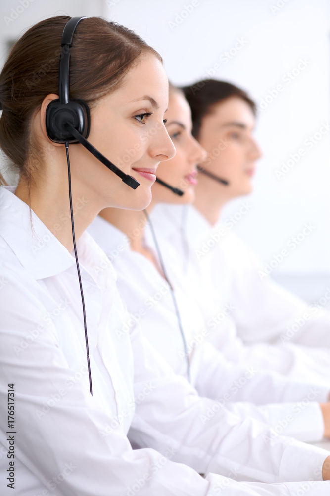 Call center. Focus on beautiful woman in headset Call center. Focus on beautiful woman in headset