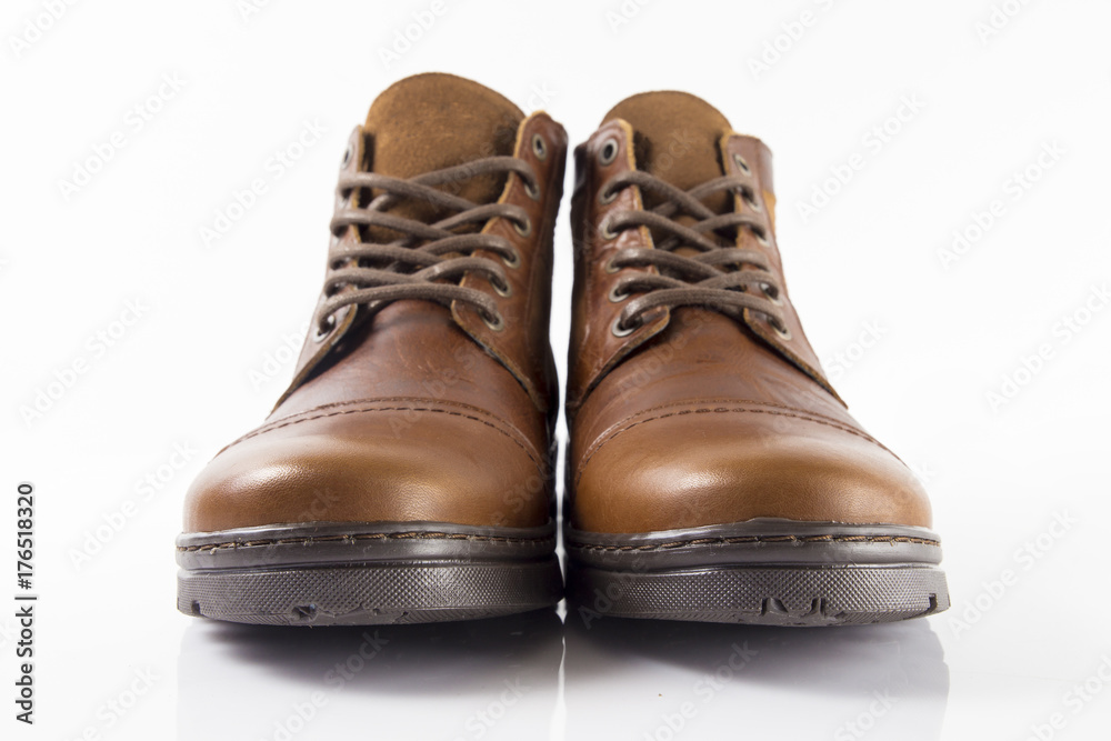 Male brown leather boot on white background, isolated product. Male brown leather boot on white background, isolated product.