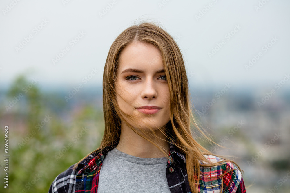 Natural makeup on the face of young girl. Portrait of attractive woman in nature.