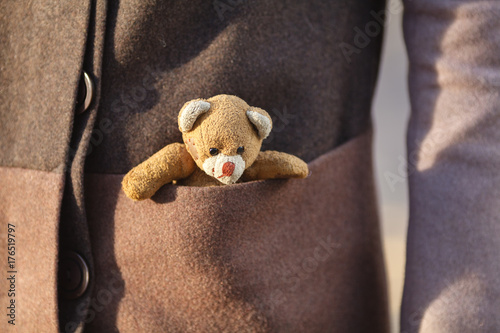 woman with a little teddy bear toy at outdoor