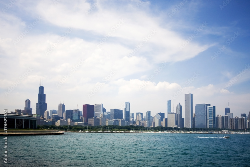Modern architecture and urban life background. Summer cityscape with cloudy sky over Chicago downtown skyline and lake Michigan marina. Chicago, Illinois, Midwest USA. Modern architecture and urban life background. Summer cityscape with cloudy sky over Chicago downtown skyline and lake Michigan marina. Chicago, Illinois, Midwest USA.