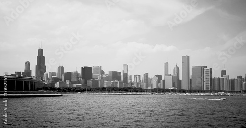 Modern architecture and urban life background.Cityscape with cloudy sky over Chicago downtown skyline, lake Michigan marina. Chicago, Illinois, Midwest USA. Black and white horizontal composition.