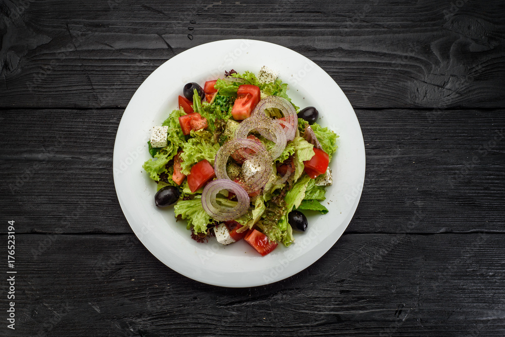Greece salad over dark wooden backround Greece salad over dark wooden backround