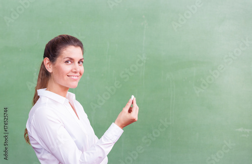 Teacher with chalk at chalkboard