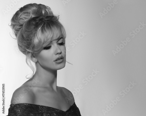 portrait of a beautiful blonde woman in retro dress 50-s style . monochrome black and white photo photo