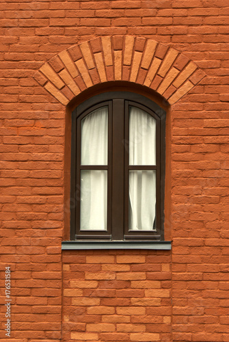 wall of an old red brick building with a window