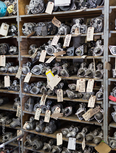 Carburetor parts shelf organized in vehicle mechanic shop with labels photo