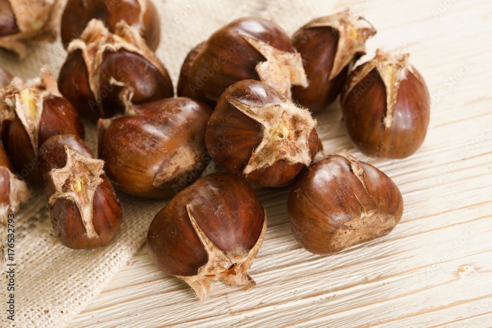 roasted chestnuts on wooden background roasted chestnuts on wooden background