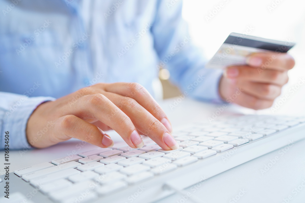 Woman using a credit card for online payments. The concept of online shopping Woman using a credit card for online payments. The concept of online shopping