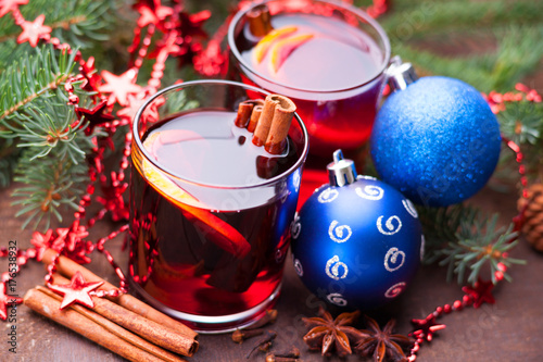 Hot mulled wine with spices, lemon and christmas balls 
