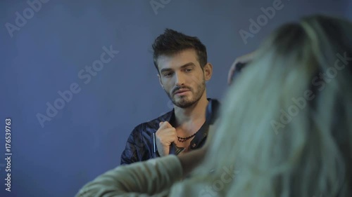 Handsome male model poses for photosession in studio 4K