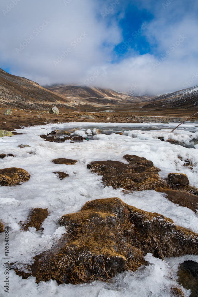 Snow flake beside River from snow ice melt on mountain Landscape view at Zero-Point, fog and mist weather day time Snow flake beside River from snow ice melt on mountain Landscape view at Zero-Point, fog and mist weather day time