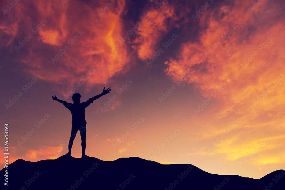 Silhouette man standing on mountain sunset background