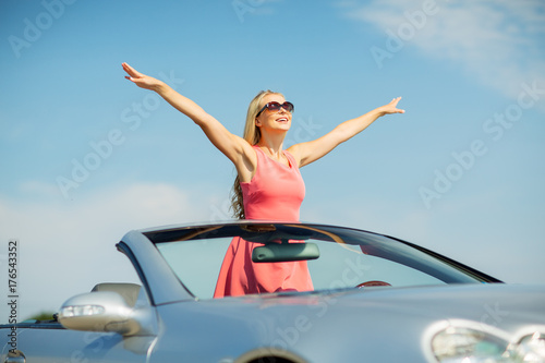 happy young woman in convertible car