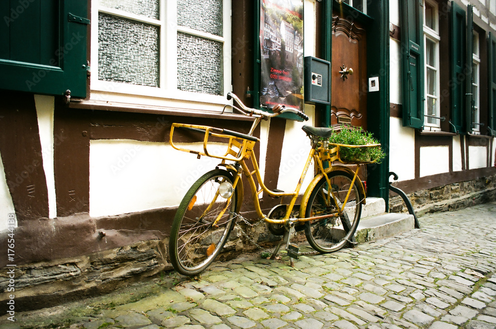 Yellow Retro Bicycle In Old European Street Germany