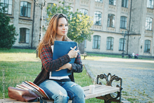 the student is sitting on the bench