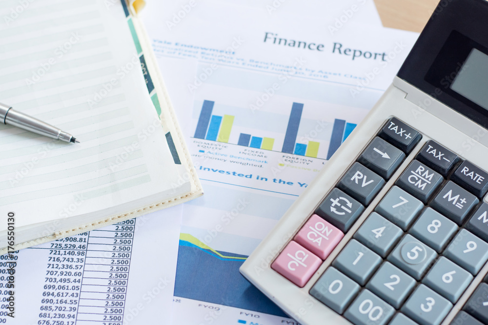 Close up pen on finance report and calculator on table office. Close up pen on finance report and calculator on table office.