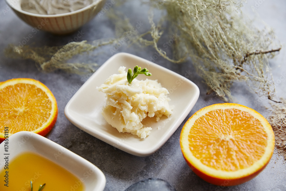 Spa still life of shea butter with orange and herbs Spa still life of shea butter with orange and herbs