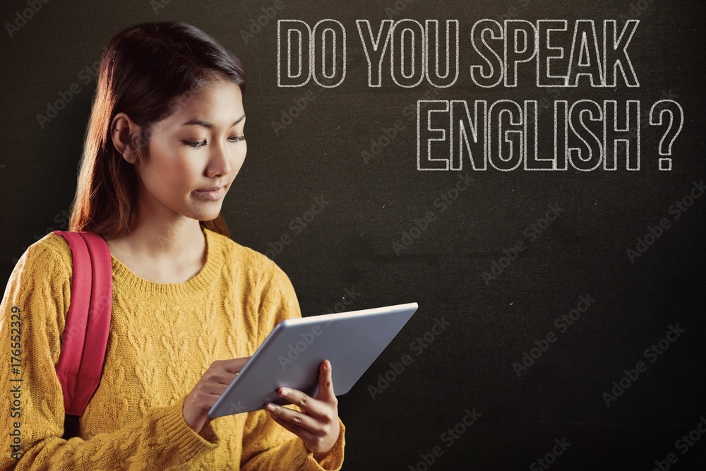 Composite image of focused asian female student using tablet Composite image of focused asian female student using tablet