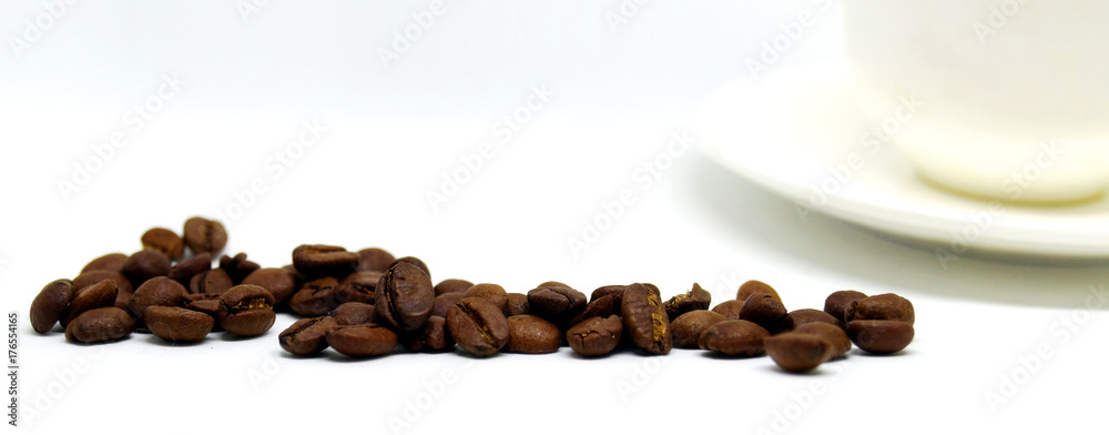Beams of coffee and white cup on the table.