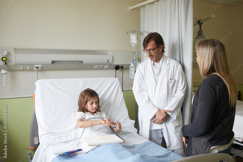 Doctor visiting and talking with a child and mother at the hospital Doctor visiting and talking with a child and mother at the hospital