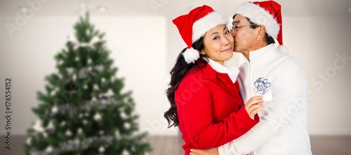 Composite image of festive senior couple exchanging gifts