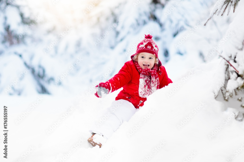 Child playing with snow in winter.Boy in snowy park. Child playing with snow in winter.Boy in snowy park.