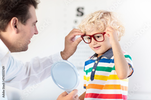 Child at eye sight test. Kid at optitian. Eyewear for kids. photo