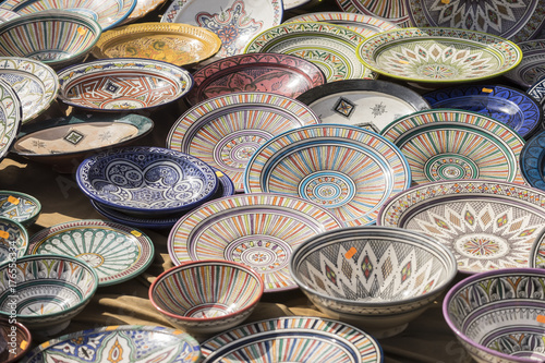 Porcelain, hand-painted dishes of a multitude of colors in a traditional art market