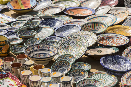 hand-painted dishes of a multitude of colors in a traditional art market