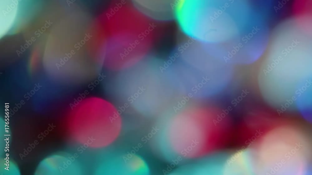 The Circles Bokeh stock video features a circle rotation in a clockwise direction of blurred gold, turquoise, red and blue lights. You can use it as an overlay for creative video effects, artistic