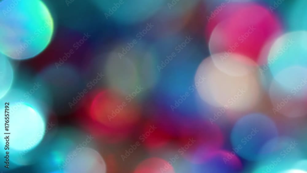 The Circles Bokeh stock video features a circle rotation in a clockwise direction of blurred gold, turquoise, red and blue lights. You can use it as an overlay for creative video effects, artistic