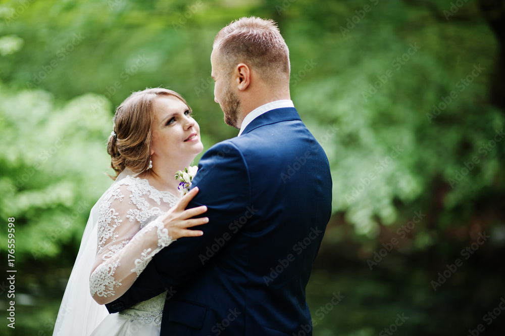 Close-up photo of a wedding couple looking each other in the eyes in nature. Close-up photo of a wedding couple looking each other in the eyes in nature.