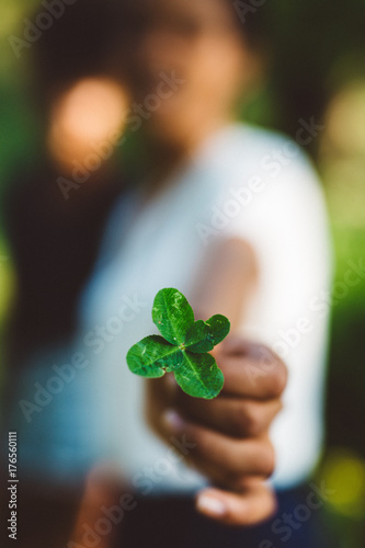 Girl holding a Four Leaf Clover photo