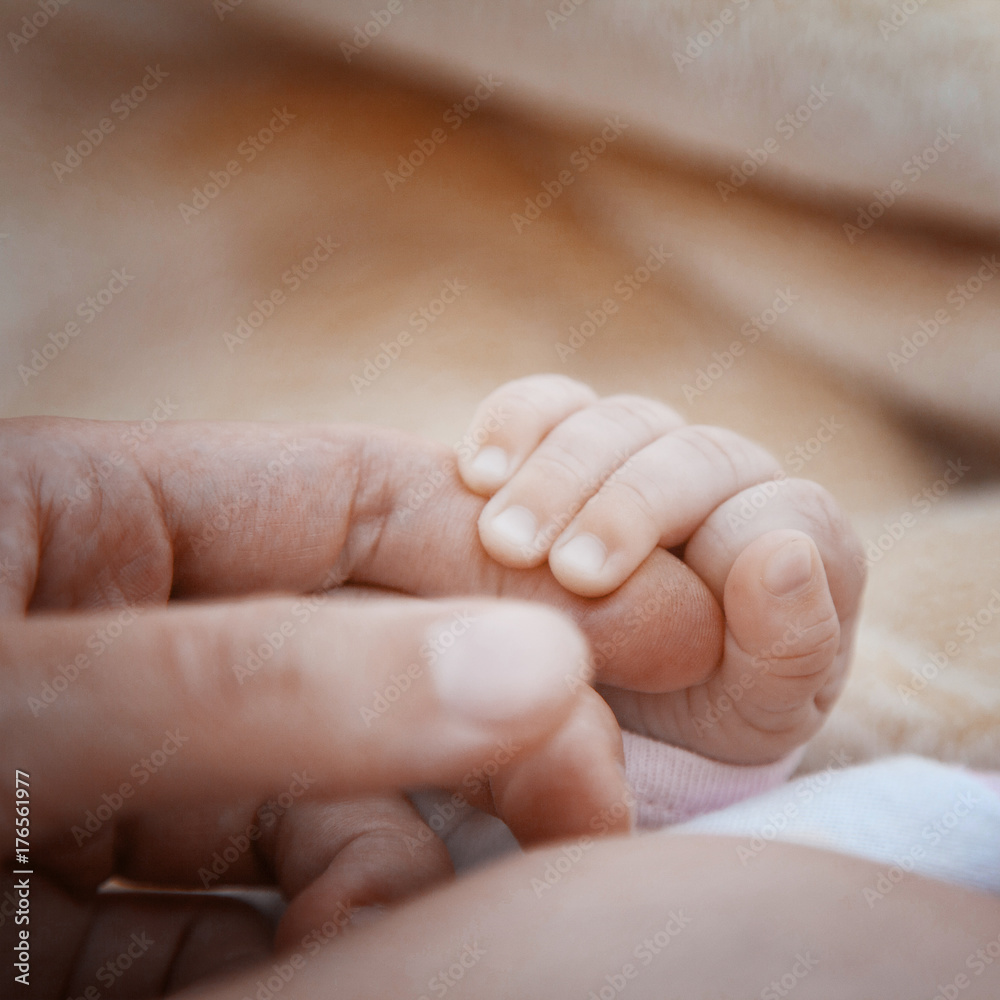 the child holds an adult finger. the concept of time flow and transfer of experience the child holds an adult finger. the concept of time flow and transfer of experience