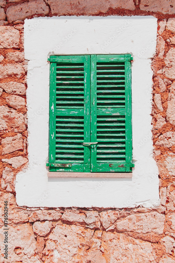 Window with colorful green wooden shutters Window with colorful green wooden shutters