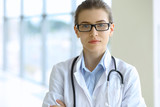 Medical doctor woman over clinic interiers background